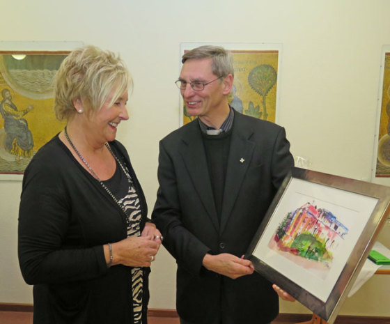 Pastor Honermann übereichte Brigitte Janßen ein Aquarell mit dem Marienheim als Motiv. Foto: Helmut Scheffler
